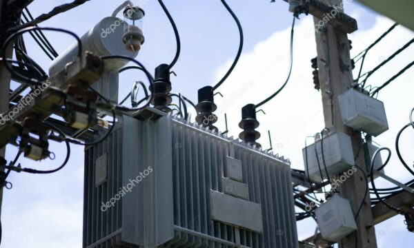 A high-voltage transformer in a cage protects against early morning current